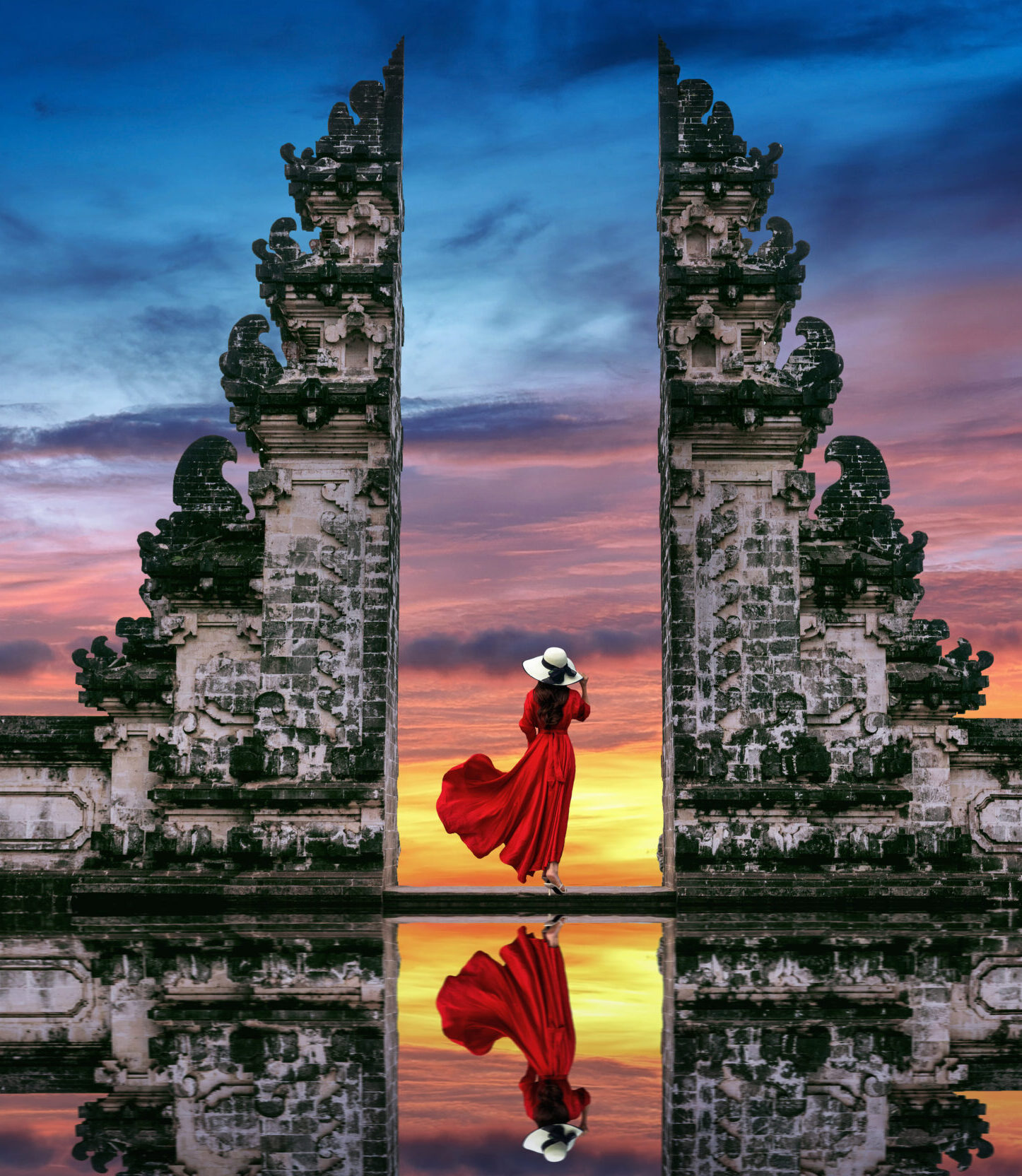 young woman standing in temple gates at lempuyang luhur temple i